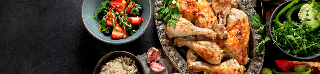Roasted chicken legs with fresh salads.