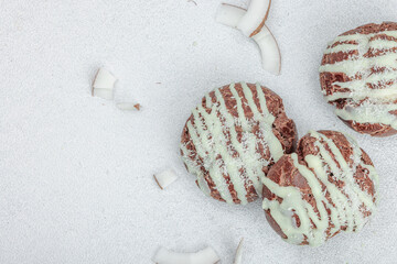 Profiteroles choux pastry buns with coconut cream served in tropical style. Palm leaves