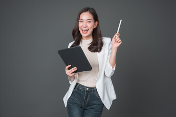 Young asian woman confident manager worker use modern technology digital tablet work remote distance isolated grey color background. Beautiful woman using smartphone. Lifestyle concept.	