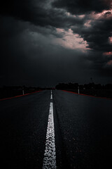 sunset in the city,wet paved road, in very dark cinematic colors,dramatic sky, storm 