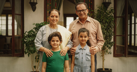 Portrait of Happy Indian Family Posing Together in Beautifully Authentic Mumbai House. Senior...