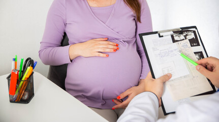 Pregnant girl at the doctor's consultation. The results of blood tests of a pregnant girl. Decrease...