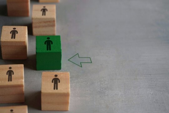 Wooden blocks with people icon and arrow. New member or new employee join group, team or company. Hiring, fill a vacancy concept