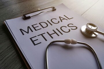 Paper clipboard with text MEDICAL ETHICS and stethoscope. Medical and healthcare concept