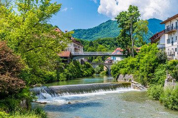 Fototapeta na wymiar A view looking up the Selca Sora river in the old town of Skofja Loka, Slovenia in summertime
