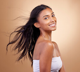 Portrait, haircare and salon for indian woman with beauty in brown studio background with glow....