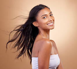 Portrait, haircare and salon for indian woman with beauty in brown studio background with glow....