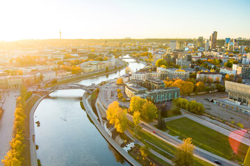 Beautiful Vilnius city panorama in autumn with orange and yellow foliage. Aerial evening view. - obrazy, fototapety, plakaty