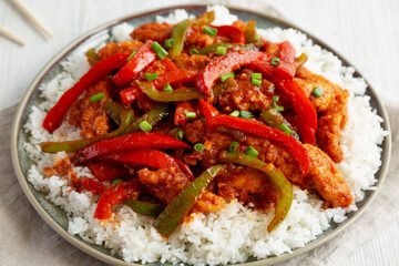 Homemade Simple Chili Chicken with White Rice on a Plate, side view. Close-up.