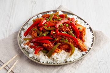 Homemade Simple Chili Chicken with Rice on a Plate, side view.