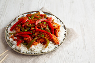 Homemade Simple Chili Chicken with White Rice on a Plate, side view. Copy space.