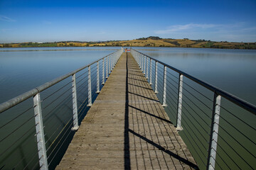Naklejka premium Wooden pier on Chiusi Lake, Tuscany, Italy.
