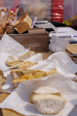 Farmer's cheese at the fair. Different types of cheese on the counter.