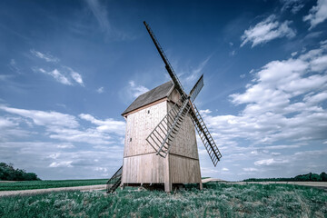 Old, traditional wooden windmill in summer scenery