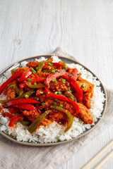 Homemade Simple Chili Chicken with White Rice on a Plate, side view. Copy space.