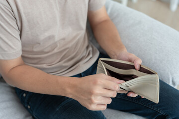 Stressed and headache man with large bills or invoices no money to pay to expenses and credit card debt. shortage, Financial problem, bankruptcy, mortgage, loan, bankrupt, poor, empty wallet