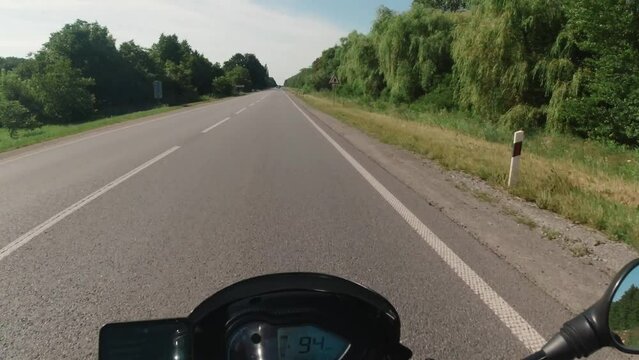 Motorcycle riding on the highway asphalt road, summer moto traveling, moto adventure concept, first person point of view, pov touring