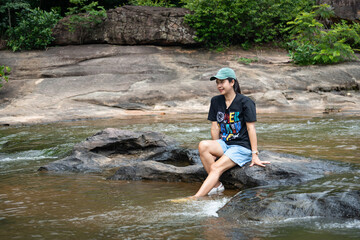 Happy holidays, nature tourism concept.The source of the river in the forest. waterfall with forest in the background. Taken in Phanom Dong Rak, Thailand.