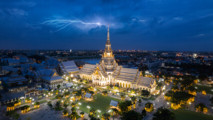 Aerial photo  night of Wat Sothon Wararam Worawihan, with lightning in the background  in Chachoengsao Province Thailand. - obrazy, fototapety, plakaty