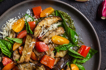 Warm eggplant, pepper, tomato and basil salad