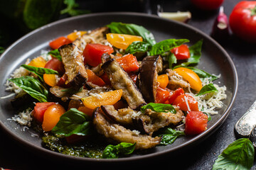 Warm eggplant, pepper, tomato and basil salad