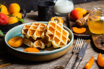 Cottage cheese wafers with apricots and honey in a bowl