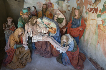 Fototapeta na wymiar VARALLO, ITALY - JULY 17, 2022: The sculptural group of Pieta (Deposition) in the chapel of church Basilica del Sacro Monte by Giovanni D’Enrico (1638-1640).