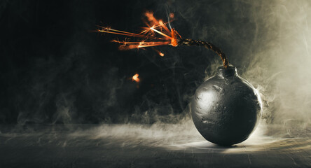 Round black bomb with lit fuse burning and sparking surrounded by smoke. Bomb about to detonate symbolizing destruction, threats, or dangerous violence. - obrazy, fototapety, plakaty