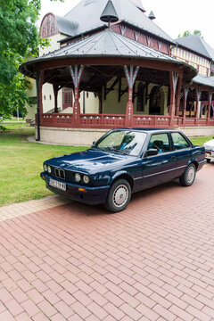 BMW 3 (E30) - blue ocean wave color is parked in Palic Park, Subotica, Serbia, 02.07.2023 (vertical image)