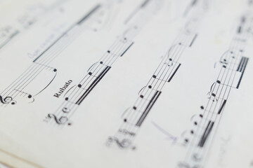 close up of musical notation and musical notes on a sheet of paper