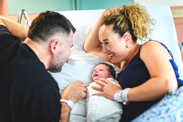 New born baby boy with the family in the hospital room