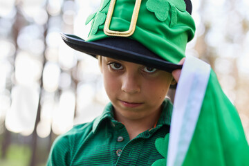 St Patricks Day celebration. Cute little boy in leprechaun hat posing outdoor.