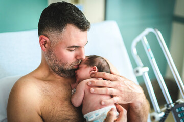 Fototapeta premium New born baby boy resting in father arms