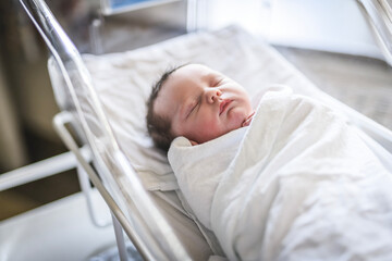 Adorable Caucasian Newborn Child Lying in Hospital Bed