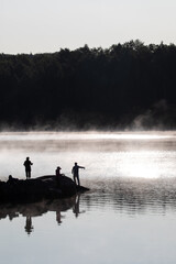 Majestic Serenity: Silhouette of Unknown Anglers Fishing on a Northern Ontario Lake - Perfect Camping and Getaway Moment.  Photography. 