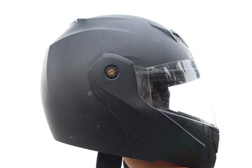 A Matte Black Helmet held in hand in a White Isolated background 
