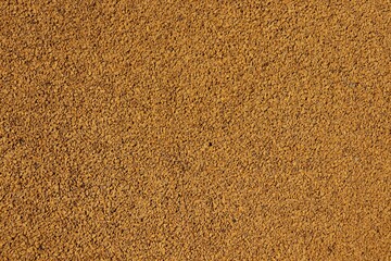 Background, texture pavement pavement made of fine recycled rubber brown