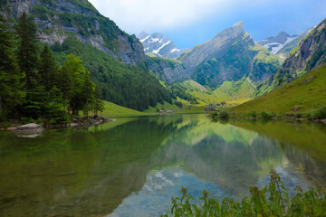 Fototapeta na wymiar Picturesque Seealpsee, an idyllic alpine lake in the Alpstein range of the canton of Appenzell Innerrhoden, Switzerland. 