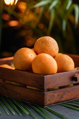 Fresh orange fruit on a wooden basket, creative fruits photography