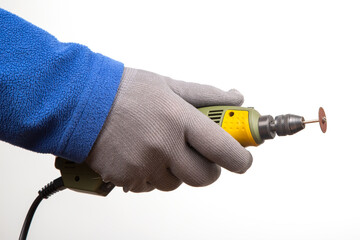 Engraving tool for cutting and processing metal and other objects in hand on a white background....