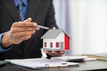 Fototapeta premium Real estate agents are offering sample homes to customers to choose the right home within their real estate office. The concept of buying a home from a reliable real estate agent