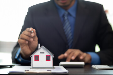 The real estate agent is reviewing the documents and calculating the interest rate to inform the...