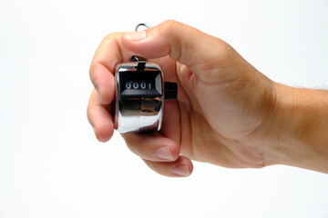 Manual mechanical counter in hand on white background.