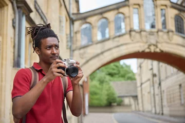 Papier Peint photo Pont des Soupirs Young Man Travelling On Vacation Taking Photo With Camera When Sightseeing In Oxford