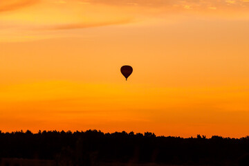 Hot air balloon flying at sunset sky