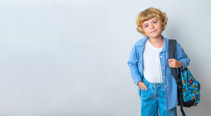 Primary school smiling boy girl with backpack showing smiling at camera. Copy space for advertising blank concept. Back to school. Childhood, education, products for children Vertical