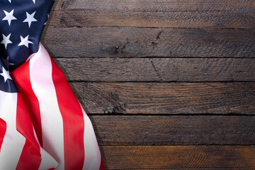 Top view overhead America United States flag, memorial remembrance and thank you of hero, studio shot with copy space on wooden table background, USA holiday Veterans or Independence day concept.