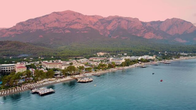 beauty of Kemer from a new perspective with breathtaking aerial view, showcasing a stunning panorama of hotels nestled amidst the scenic mountain landscape.