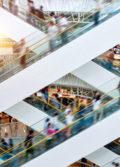 People on many fast moving escalators in modern shopping mall © xy