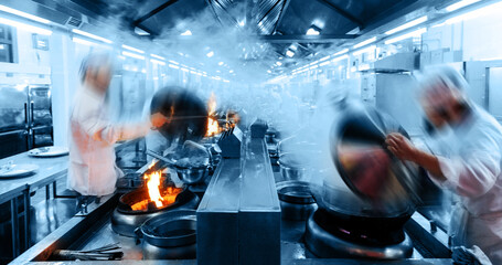 Motion chefs working in Chinese restaurant kitchen